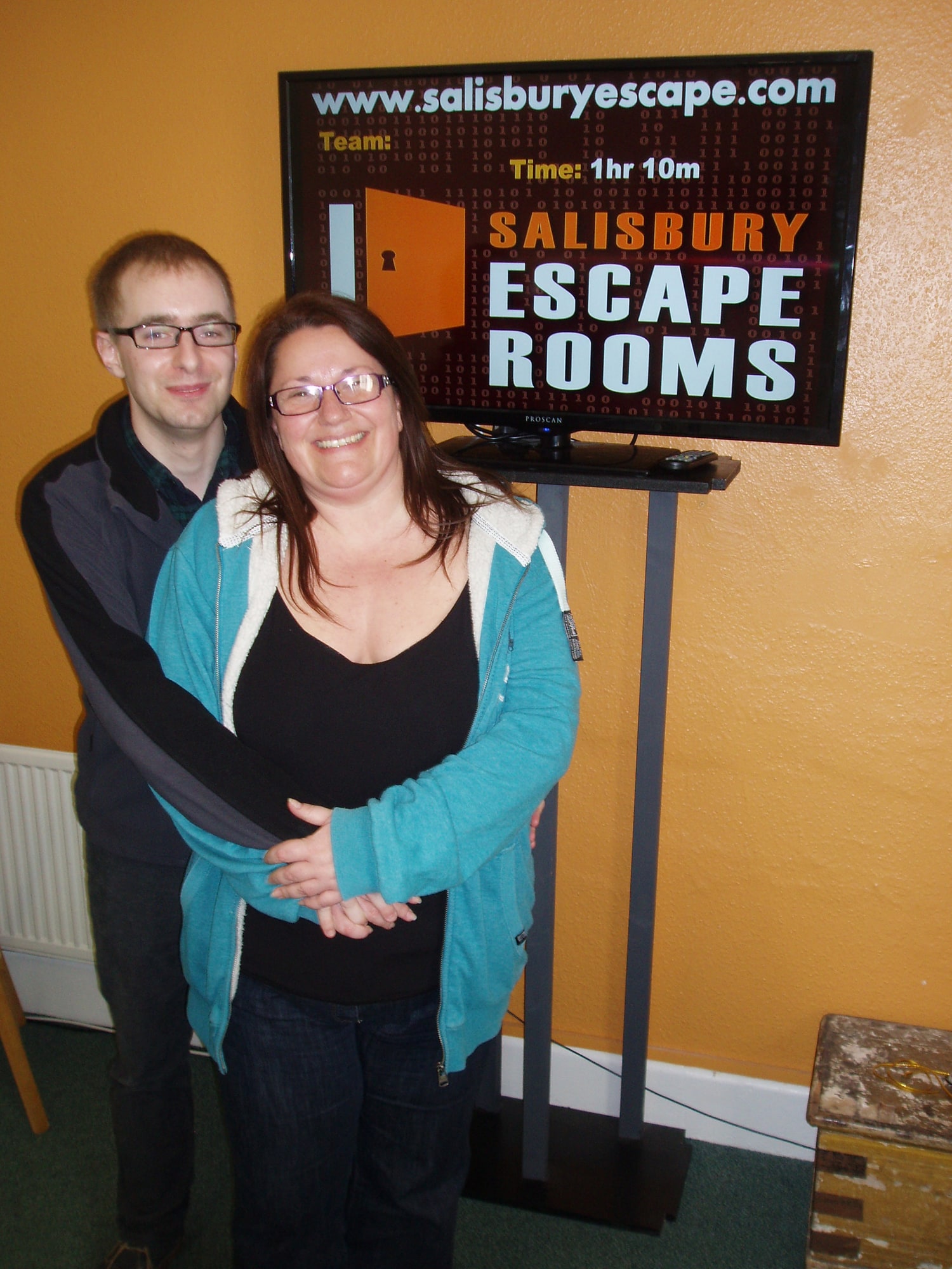 Anthony and Trenna pose beside the Salisbury Escape Rooms results screen after their early Salisbury game.
