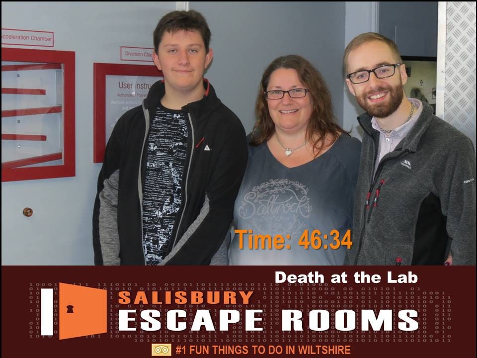 A three-person team pose after Death at the Lab at Salisbury Escape Rooms, in the Salisbury laboratory-themed finish photo.