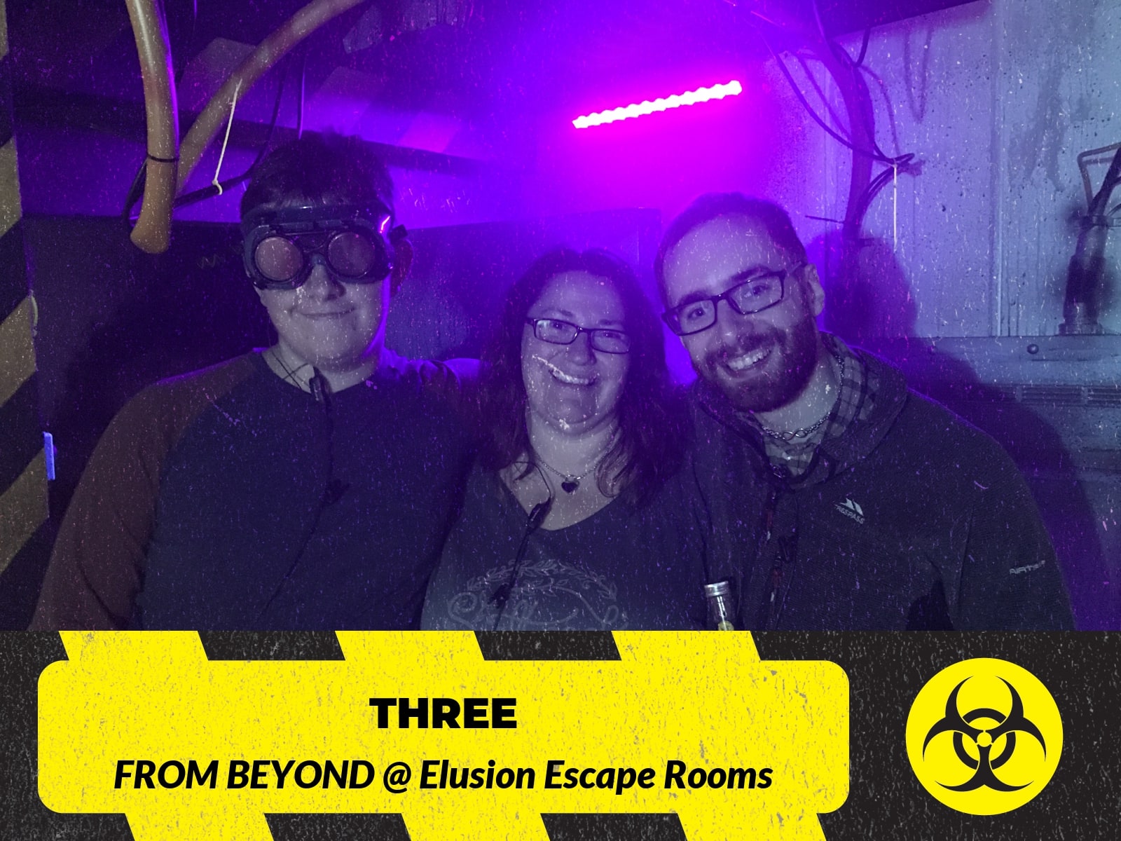 A three-person team pose after From beyond at Ellusion, beneath From Beyond branding in purple light.