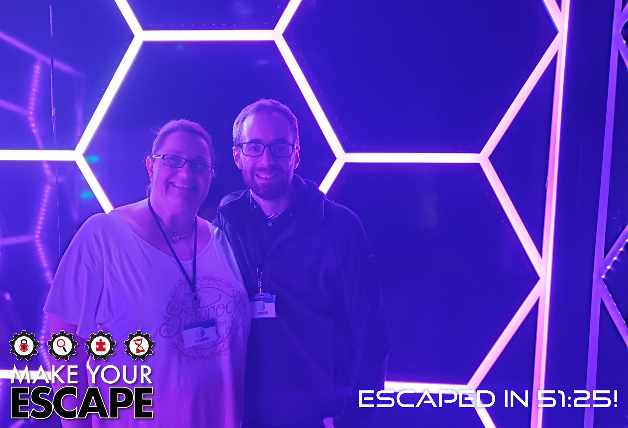 Anthony and Trenna pose after Utopia at Make your escape, before the neon hexagon finish wall.