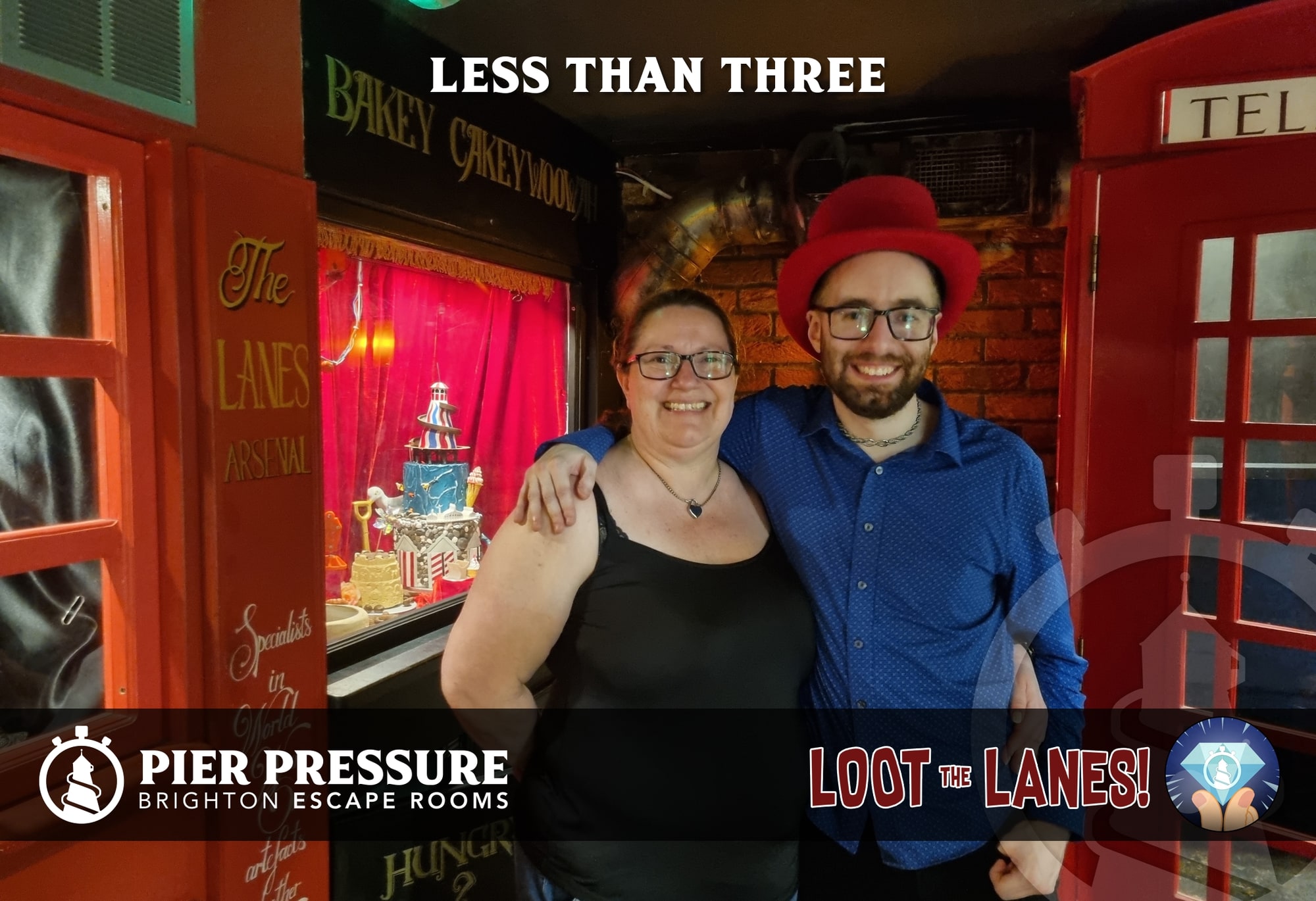 Anthony and Trenna pose after Loot the Lanes at Pier Pressure, in the Loot the Lanes street scene beside a red phone box.