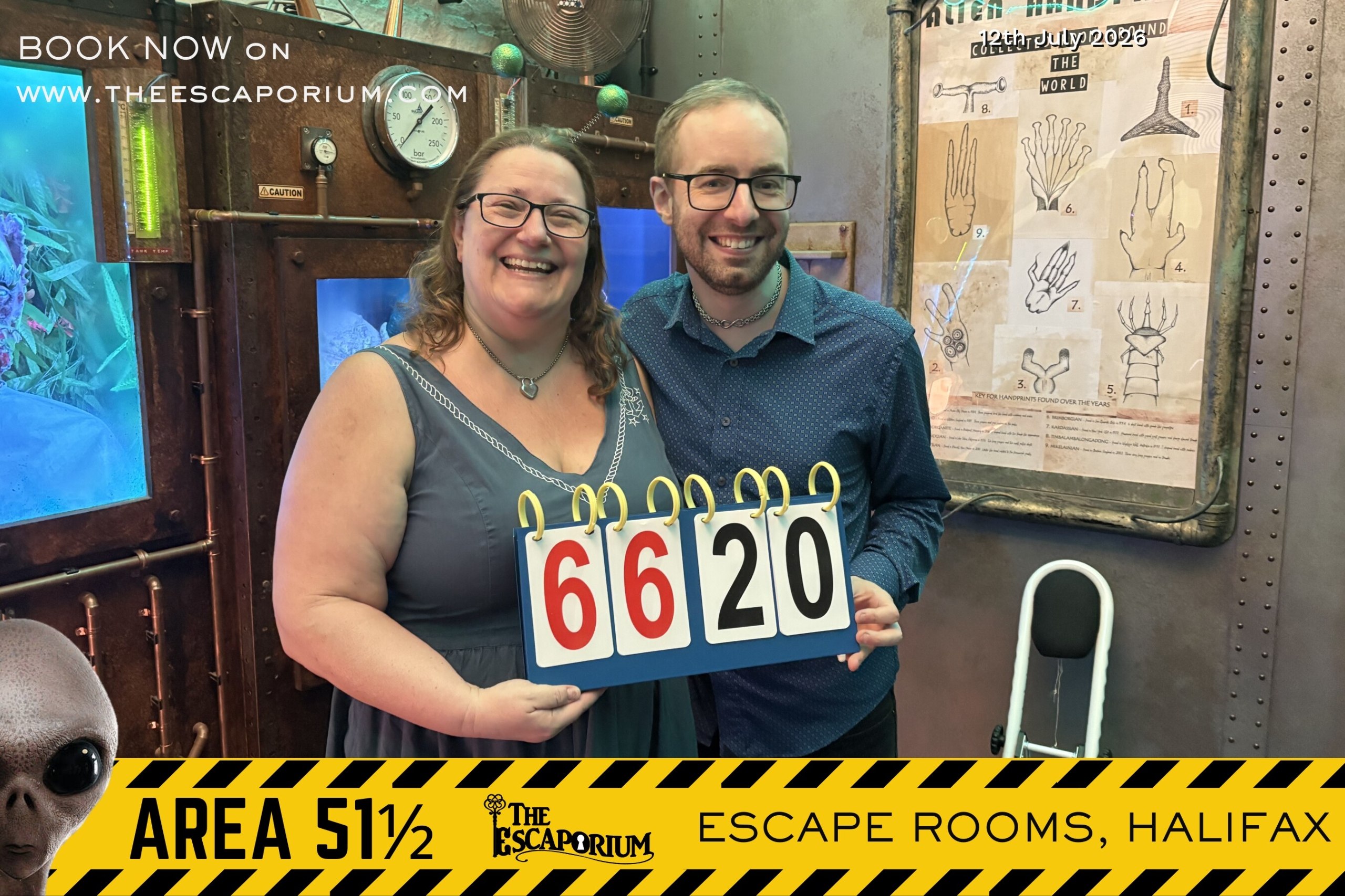 Anthony and Trenna smiling after completing Area 51.5 at Escaporium, holding the 66:20 result board in the laboratory set.